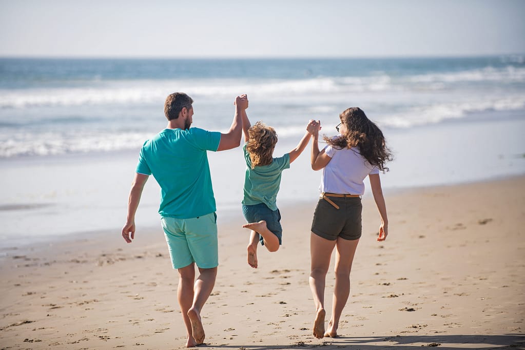 Happy Family Holidays. Joyful Father, Mother, Baby Son Walk Of S