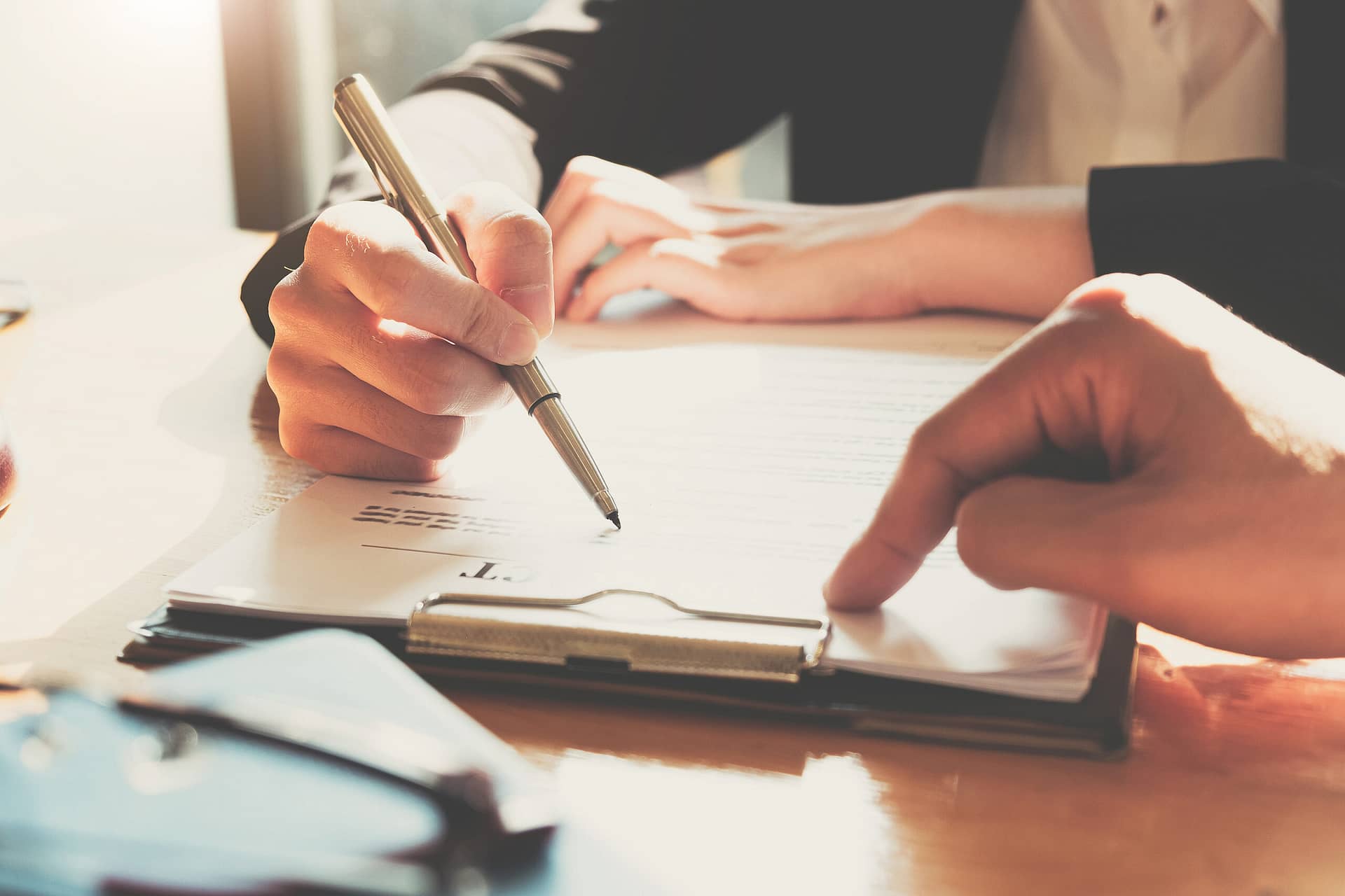 Business Woman Signing A Contract. Close Up Of Two Business Part