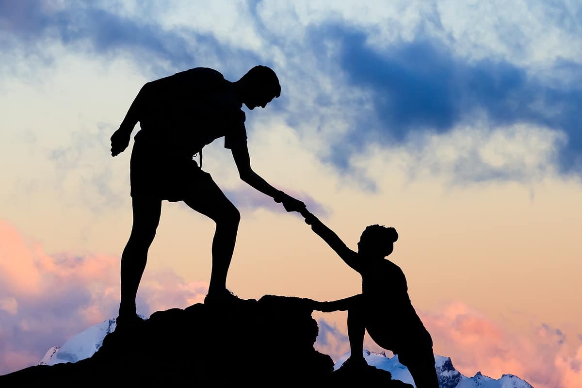 Teamwork Couple Helping Hand, Trust In Mountains. Team Of Climbe